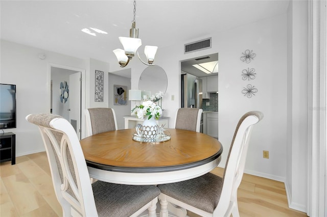 dining room featuring a chandelier and light hardwood / wood-style floors