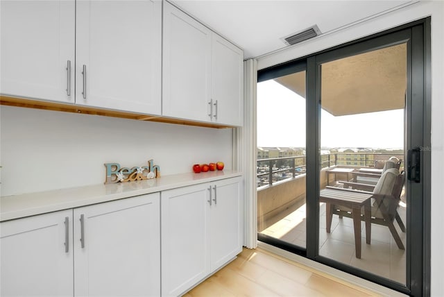 interior space with white cabinetry and floor to ceiling windows