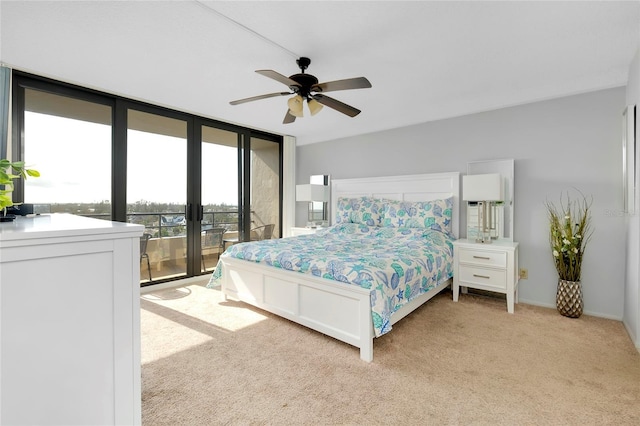 carpeted bedroom with floor to ceiling windows and ceiling fan