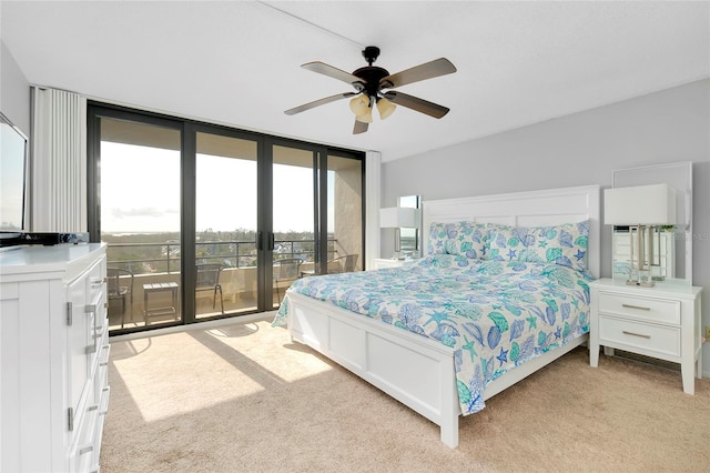 bedroom with ceiling fan, floor to ceiling windows, light carpet, and access to outside