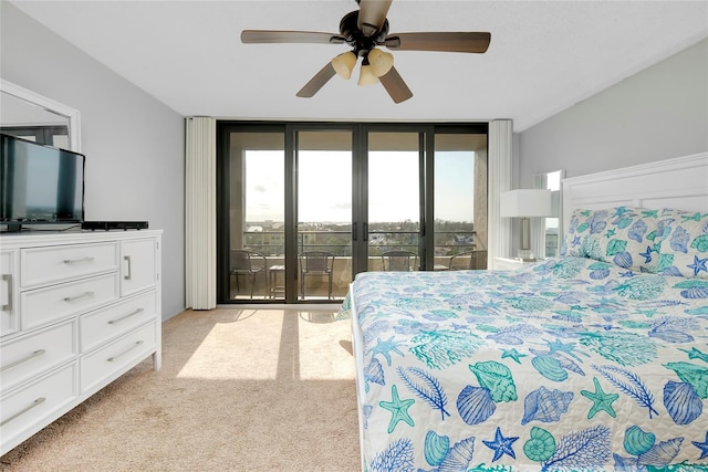 bedroom featuring a wall of windows, access to outside, ceiling fan, light carpet, and french doors