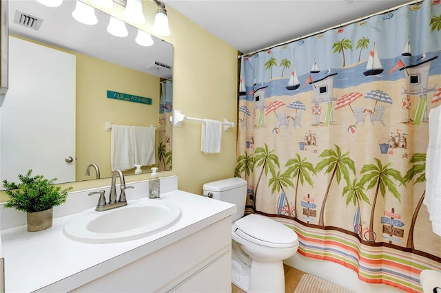 bathroom featuring vanity, curtained shower, and toilet