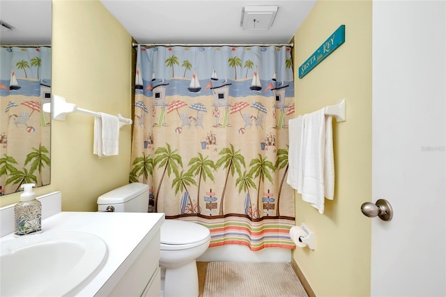 bathroom featuring vanity, a shower with shower curtain, and toilet