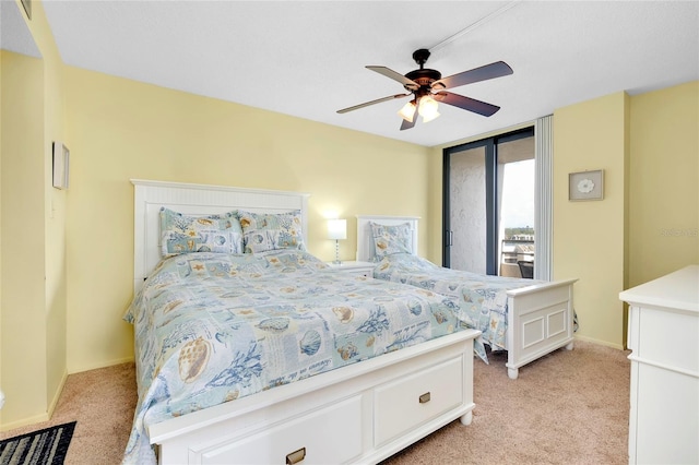 bedroom featuring light colored carpet and ceiling fan