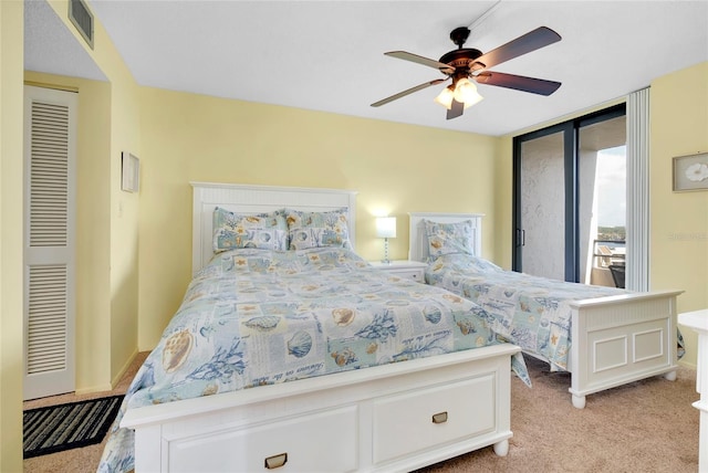 bedroom featuring light colored carpet and ceiling fan