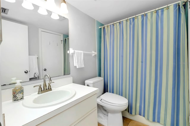 bathroom with vanity, a shower with curtain, tile patterned floors, and toilet