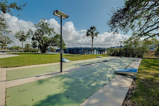 surrounding community with a lawn and a water view