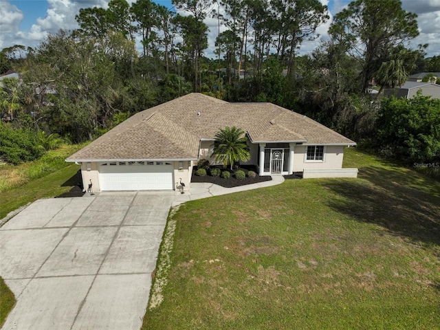 single story home featuring a garage and a front lawn