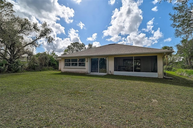 rear view of house featuring a yard