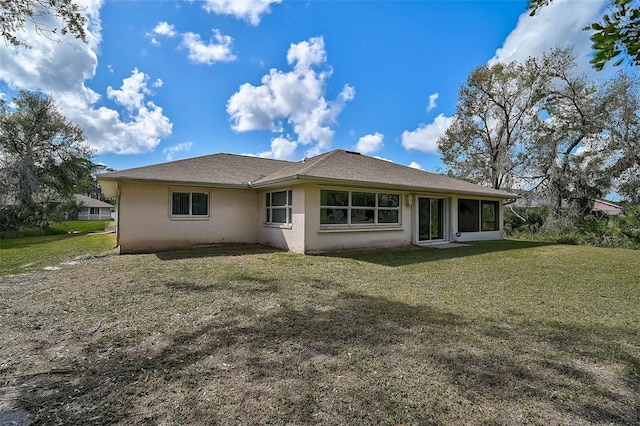 rear view of property with a yard