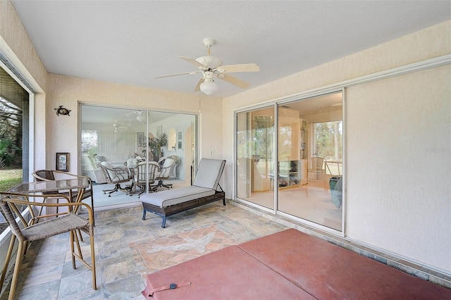 sunroom with a wealth of natural light and ceiling fan