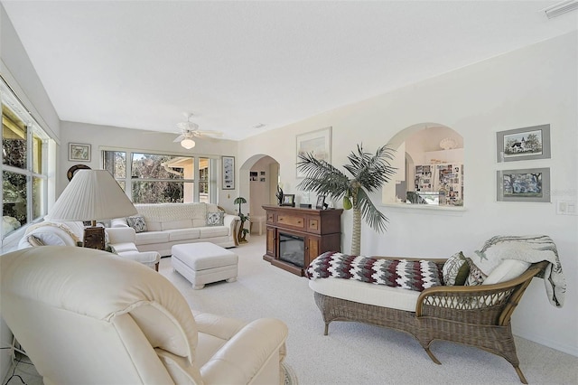 carpeted living room featuring ceiling fan