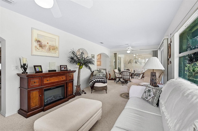 living room featuring light carpet and ceiling fan