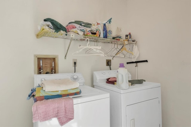 clothes washing area with washing machine and dryer