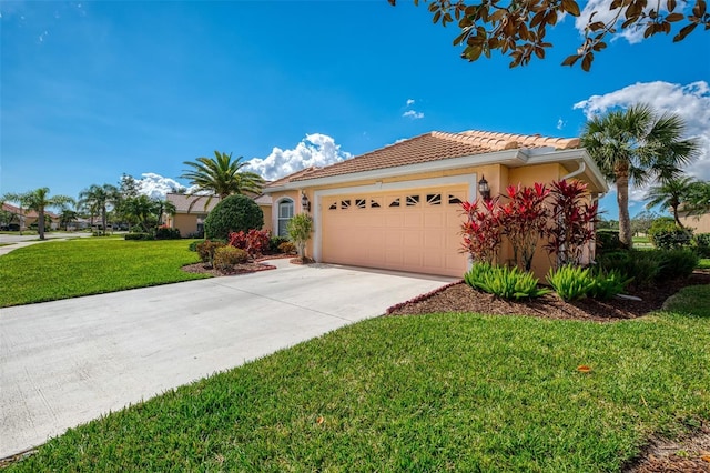 mediterranean / spanish house with a garage and a front lawn