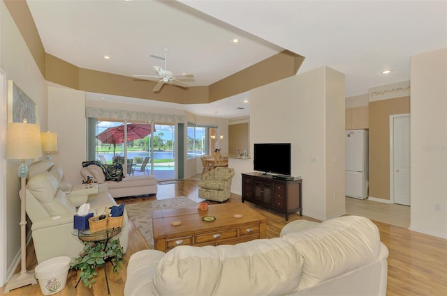 living room featuring ceiling fan and light wood-type flooring