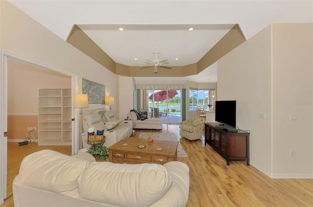 living room with ceiling fan and light wood-type flooring