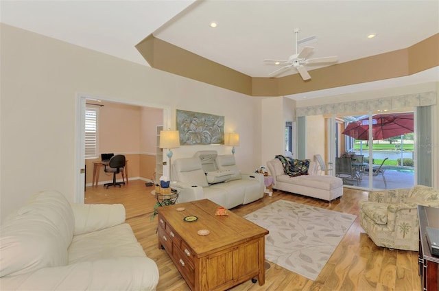 living room featuring ceiling fan and light wood-type flooring