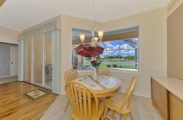 dining room with light hardwood / wood-style floors and a chandelier