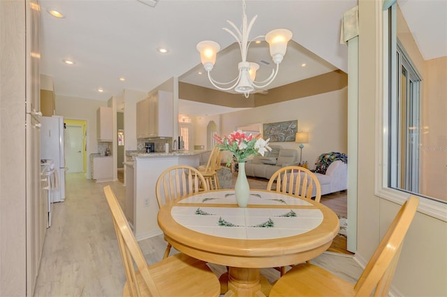 dining room with an inviting chandelier and light hardwood / wood-style flooring