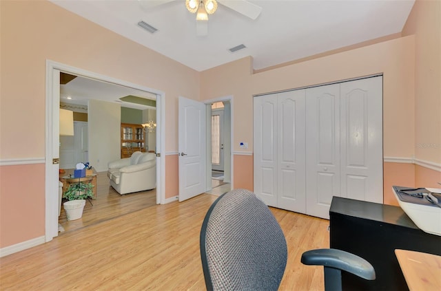 home office featuring ceiling fan and light hardwood / wood-style flooring