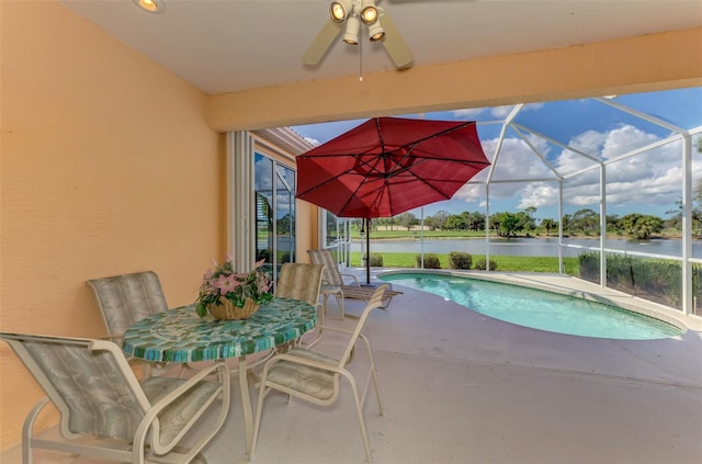 view of swimming pool featuring a water view, a patio, and a lanai