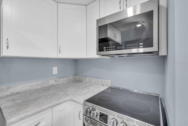 902 Gibbs Rd Unit 181, Venice, FL 34285 - kitchen with stainless steel appliances, white cabinetry, and light countertops