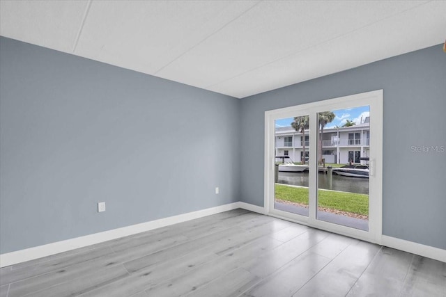 902 Gibbs Rd Unit 181, Venice, FL 34285 - spare room with baseboards and a water view