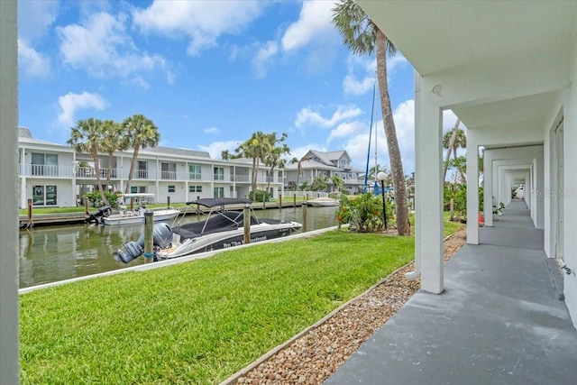 902 Gibbs Rd Unit 181, Venice, FL 34285 - dock area with a residential view, a lawn, and a water view