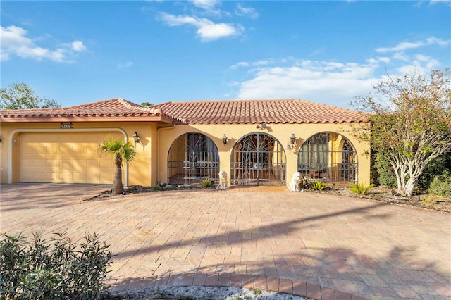 mediterranean / spanish-style house with a garage