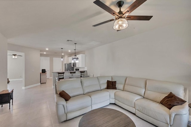 tiled living room featuring ceiling fan