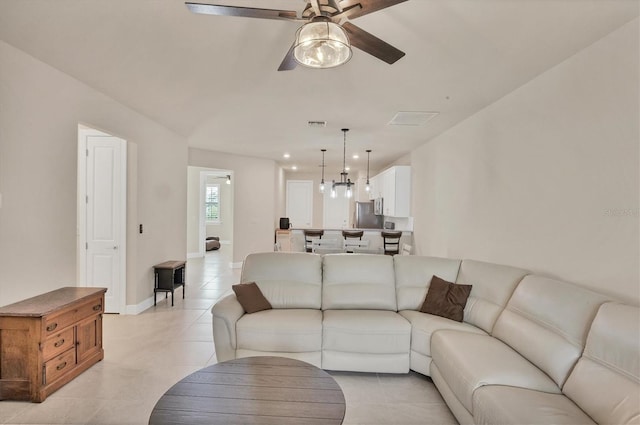 living room featuring light tile patterned floors and ceiling fan