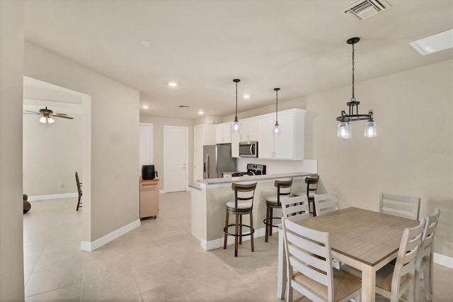 dining space featuring ceiling fan and light tile patterned flooring