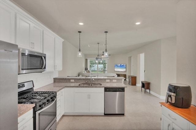 kitchen with sink, appliances with stainless steel finishes, and white cabinets