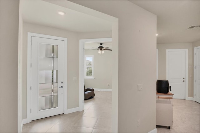 entryway with light tile patterned flooring