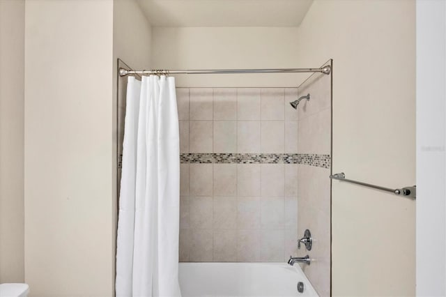 bathroom featuring toilet and shower / bath combo