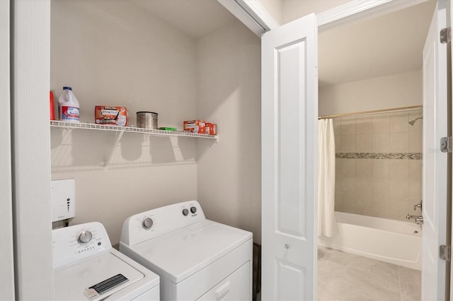 washroom featuring separate washer and dryer and light tile patterned floors