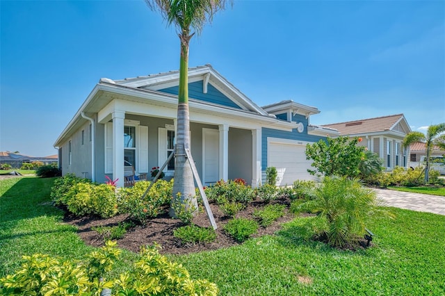 view of front of home with a front lawn, a porch, and an attached garage