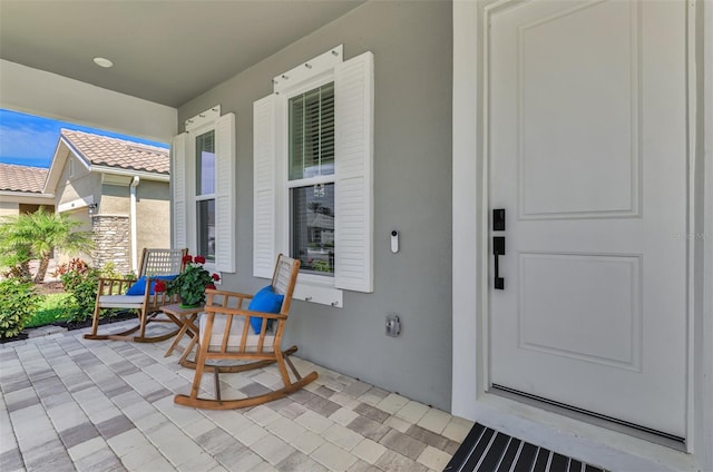 exterior space featuring a porch and stucco siding