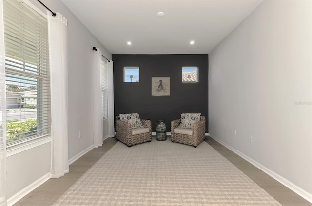 sitting room featuring recessed lighting, wood finished floors, and baseboards