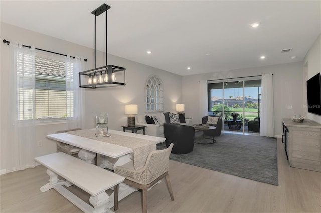 dining area with light wood-style flooring and recessed lighting