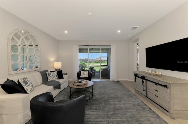 living room with recessed lighting, visible vents, and baseboards