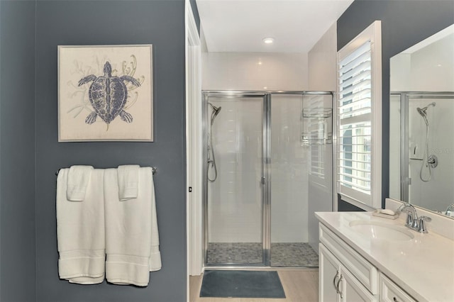 full bathroom featuring a shower stall and vanity