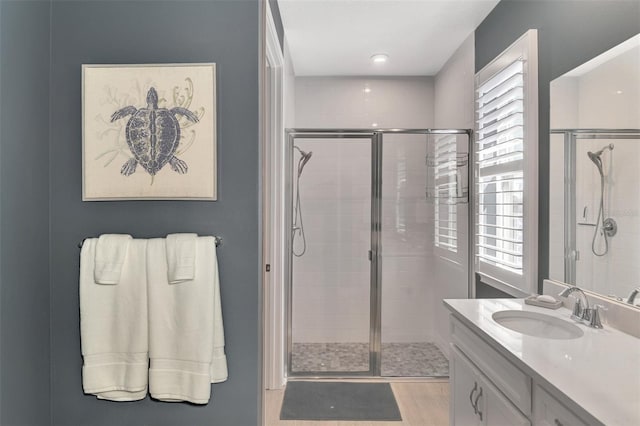 full bathroom featuring a shower stall and vanity