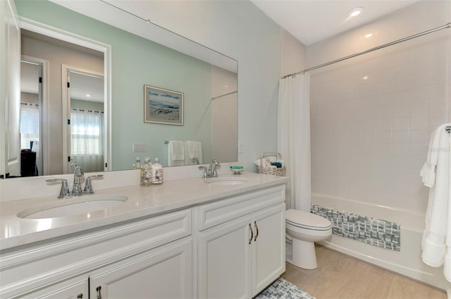 full bathroom with toilet, shower / tub combo, a sink, and wood finished floors