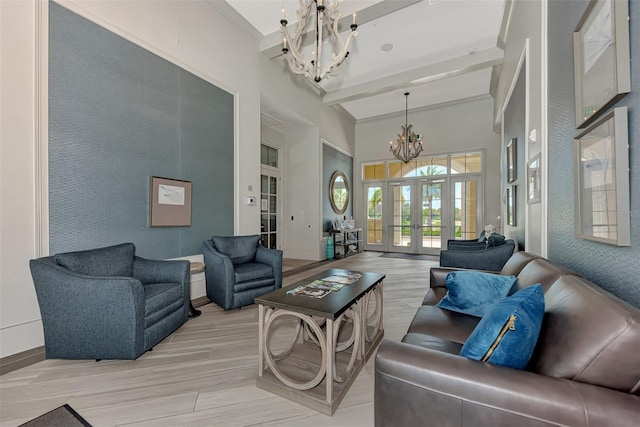 living room featuring a towering ceiling, an inviting chandelier, french doors, light wood-type flooring, and beam ceiling