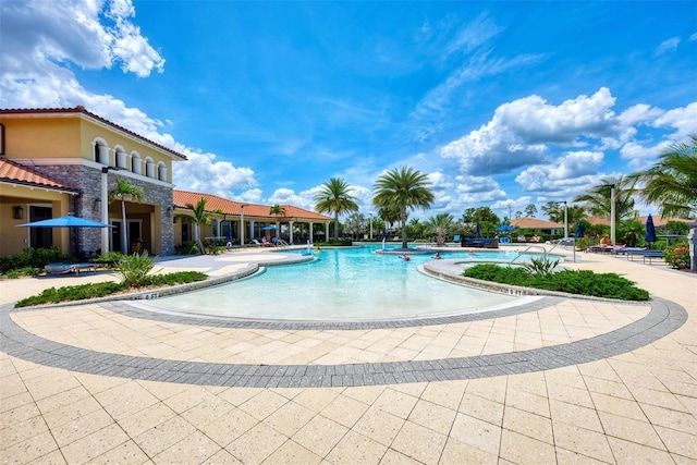 community pool with a patio area