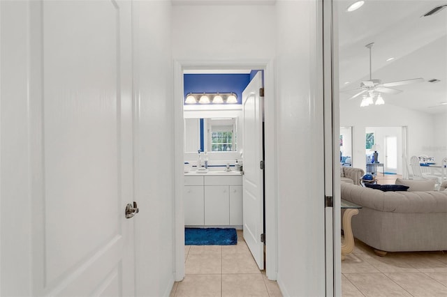 213 Venice Palms Blvd, Venice, FL 34292 - hallway featuring light tile patterned floors, a sink, and vaulted ceiling