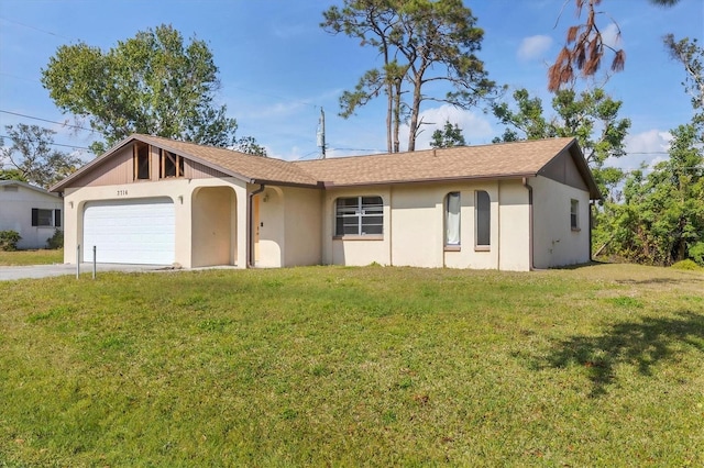 ranch-style home with a front yard, driveway, an attached garage, and stucco siding