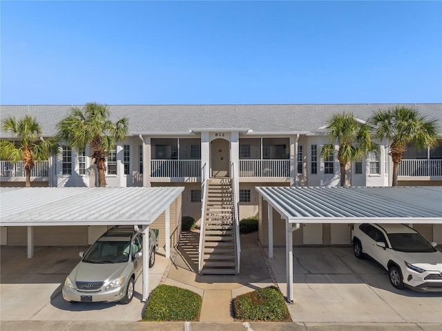 view of property featuring driveway and stairway